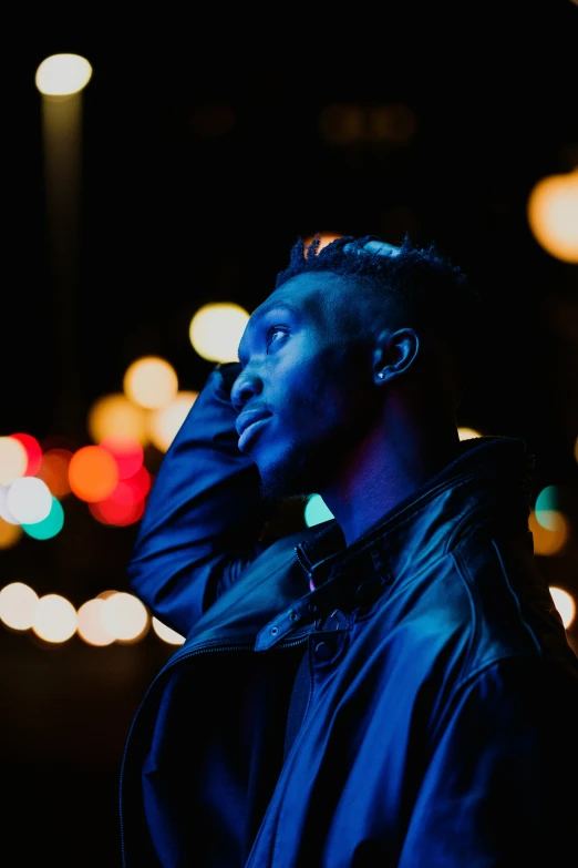 a man stands in front of his phone while using his ear buds