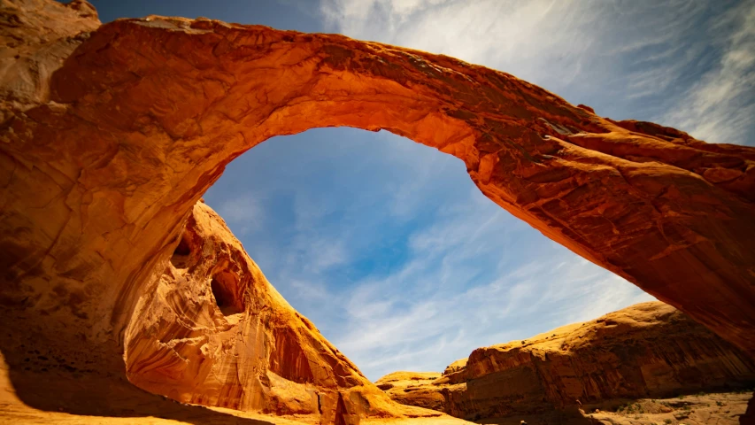 the rock formations and sky are reflected in the mirror of the picture