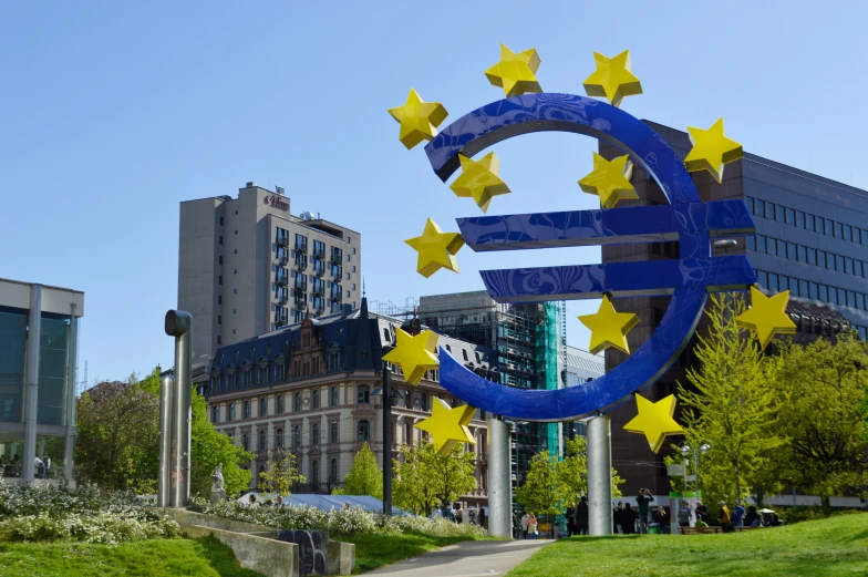 a large blue and yellow sign with stars surrounding it