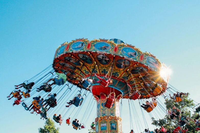 a carnival carousel ride during the day with its colorful colors