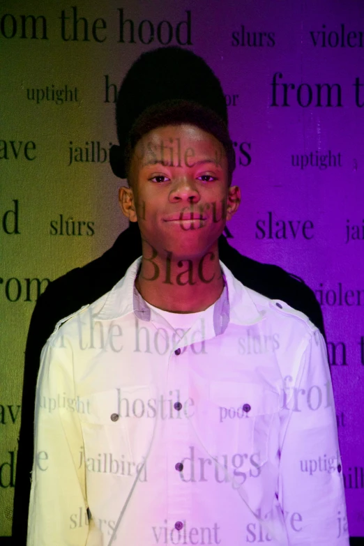 a young man wearing a white shirt with the words hate and hate written on it