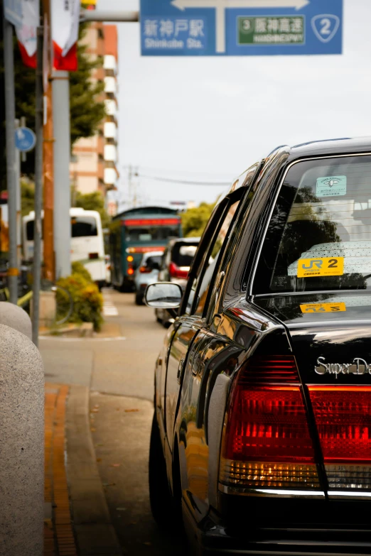 a black car with yellow and white stickers on its hood