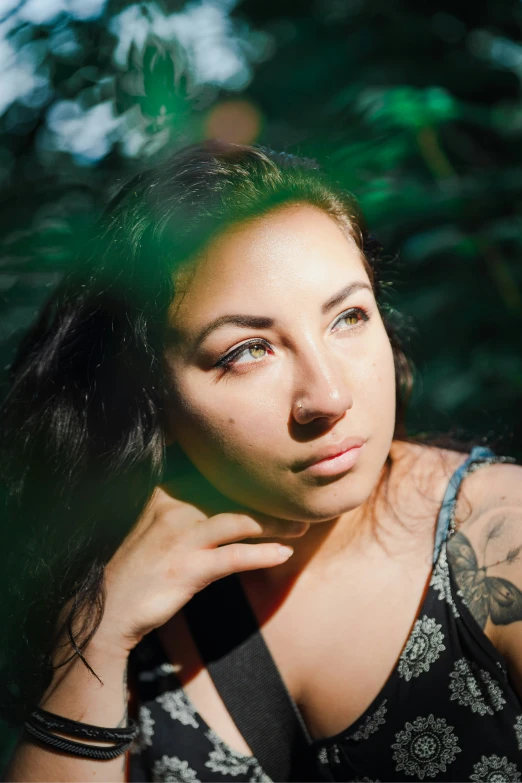 a woman with tattoos on her arm posing for the camera