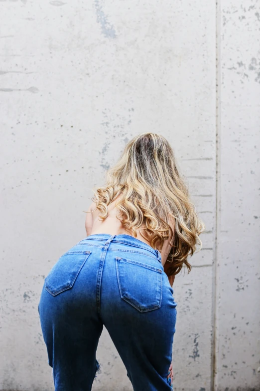 a woman is kneeling and facing away from the camera