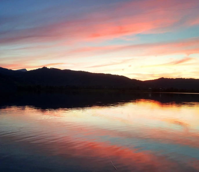 a body of water with a mountain in the background