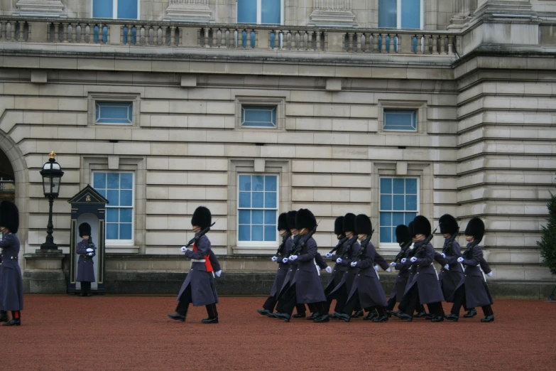 a troop of people standing outside of a building