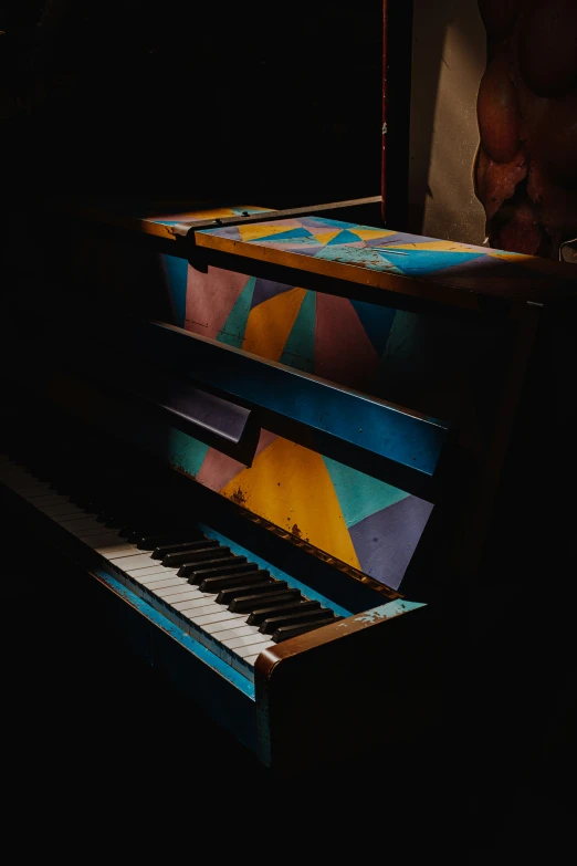 two old style piano being cleaned in the dark