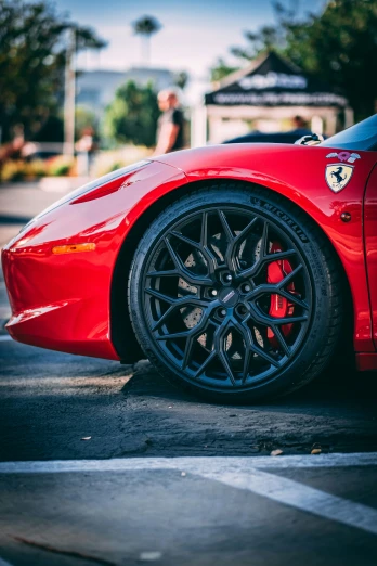 the wheels on a red sports car are visible