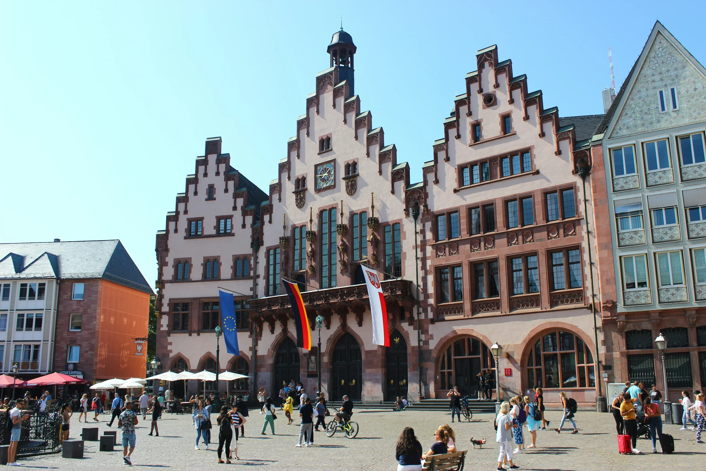 a couple of people walk around a large square