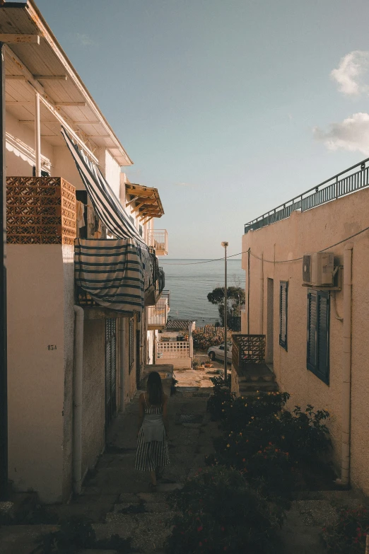 an alley with a small child walking in the distance