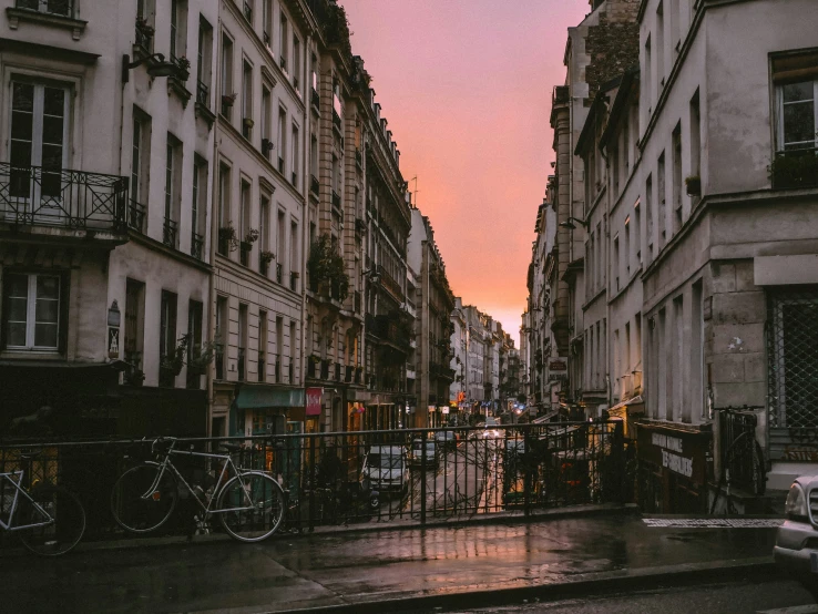 a city street in the evening with tall buildings