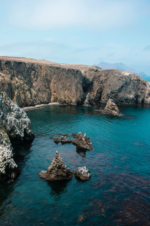 rocks and water are lying next to the ocean