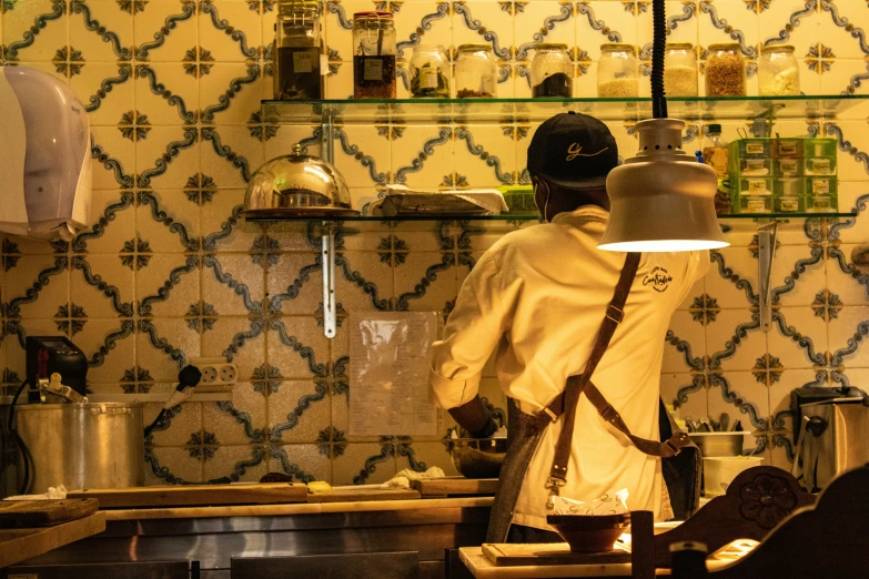 a man is working in the kitchen behind a sink