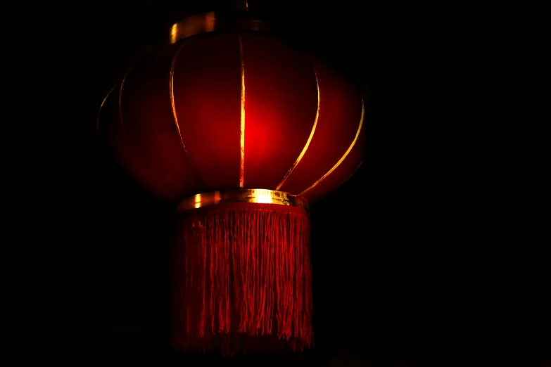 a red lamp with a dark background