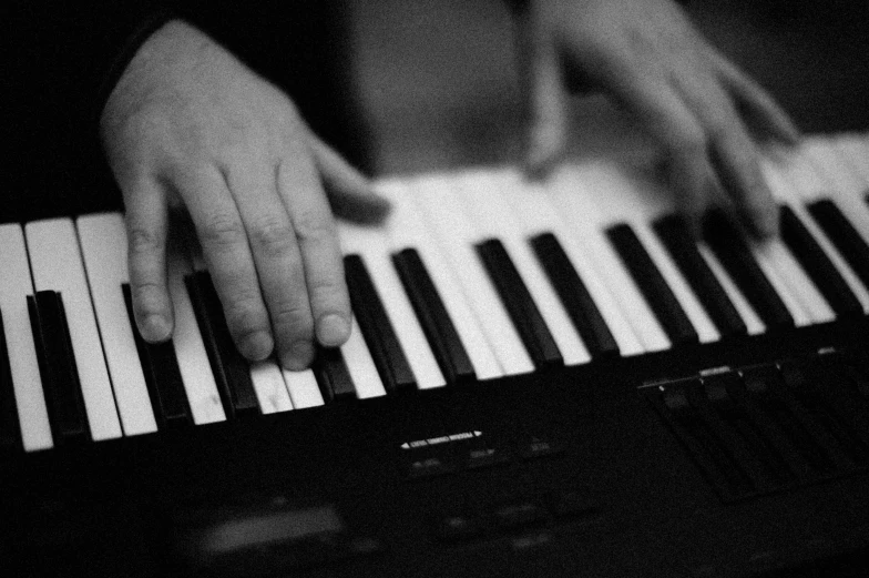 hands that are playing some kind of organ keyboard
