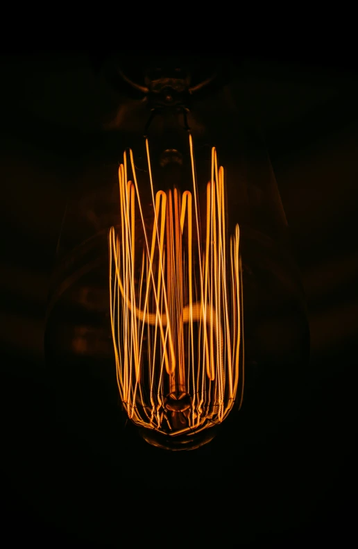 a lightbulb that is turned on and has wires in it