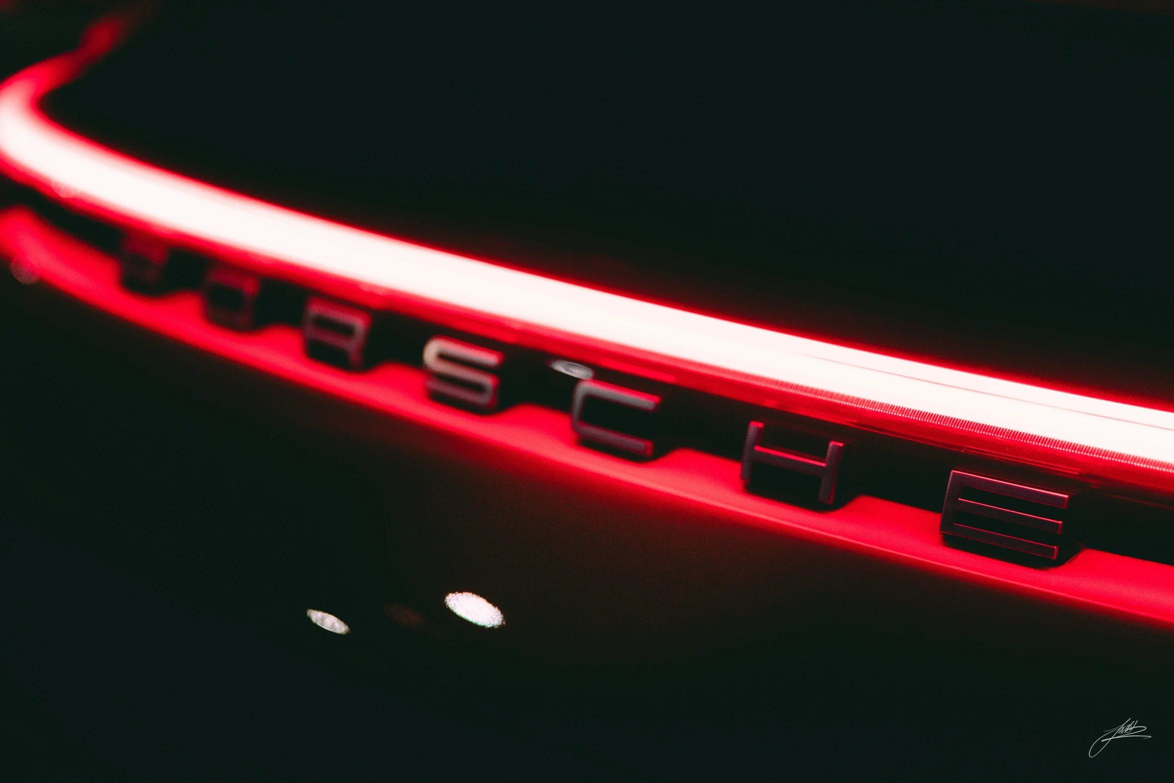 an image of the car logo with a red light in it