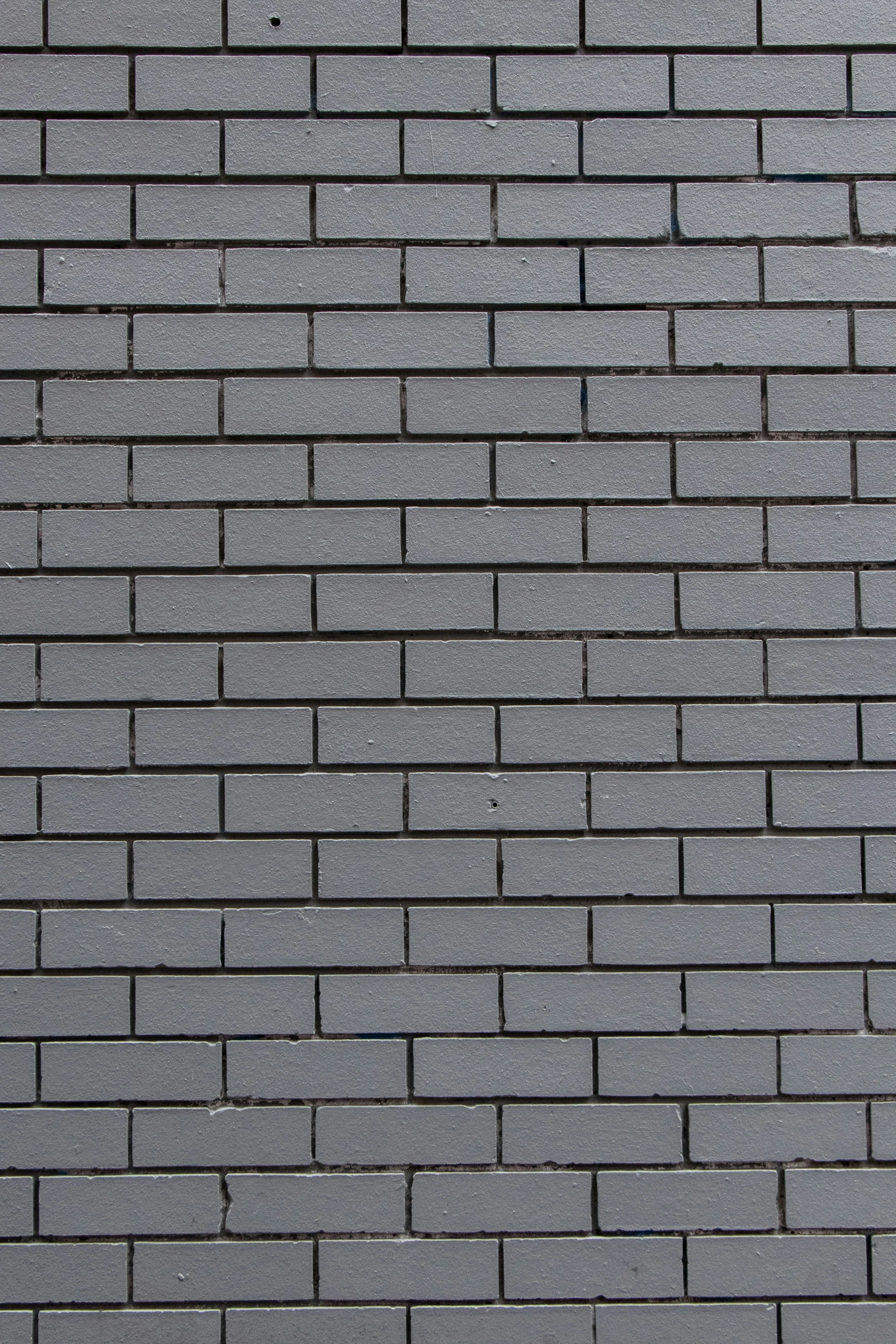 a brick wall is black with very little bumps