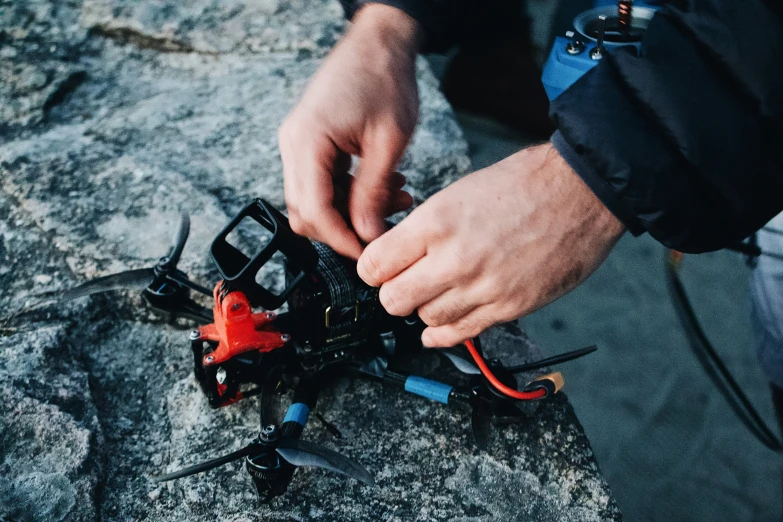 a man putting the wires into a small toy