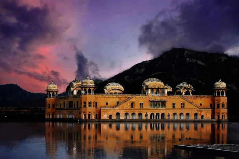 a large old building sitting on top of a lake