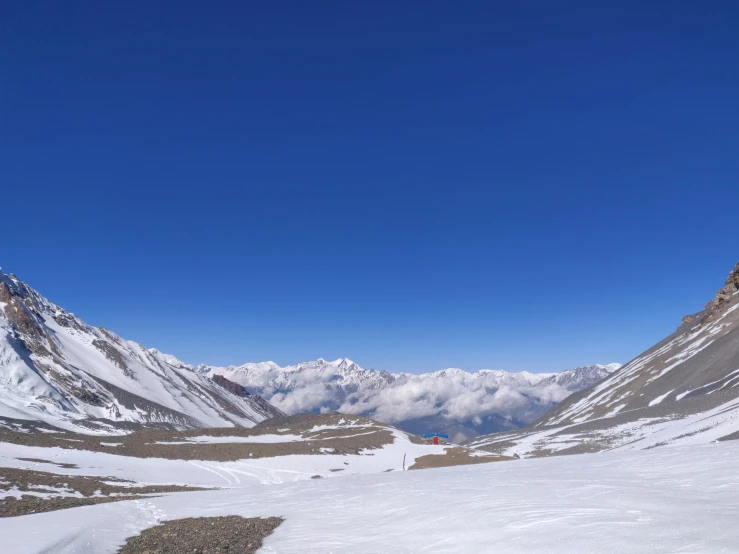 the snowy mountains surround a deep blue sky