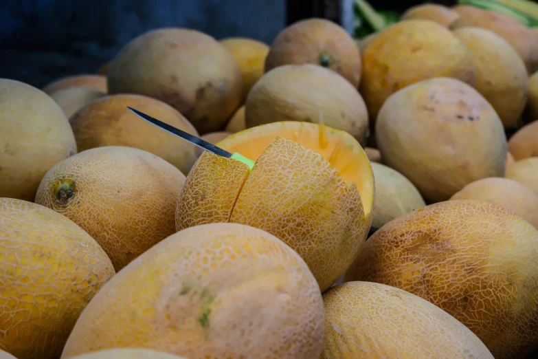 close up of a closeup of fruit and a knife