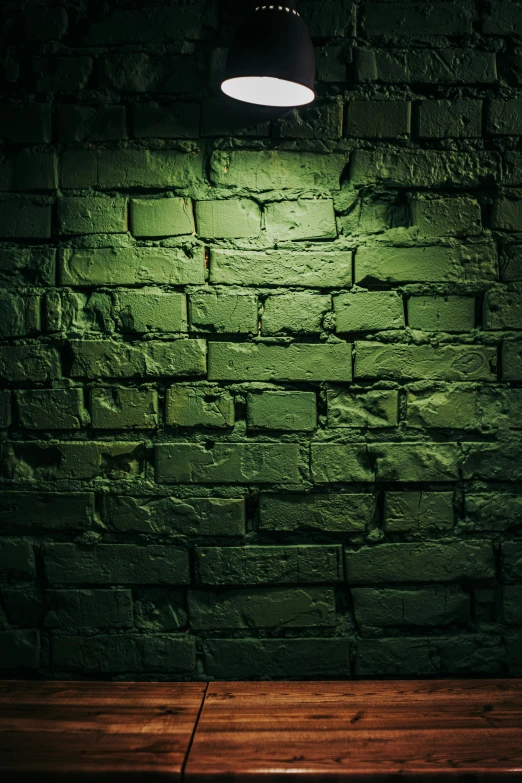 an old brick wall, with one lamp glowing on it