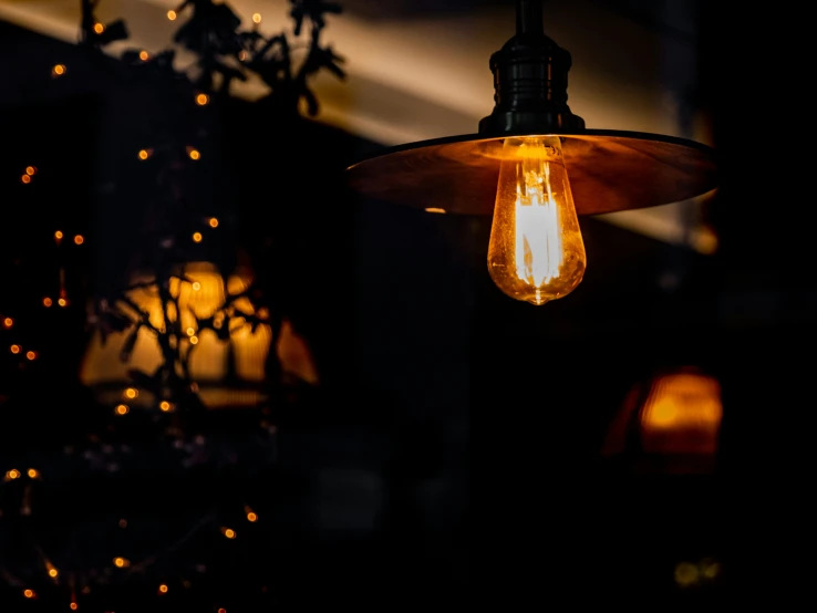 an antique - style hanging light fixture in the dark