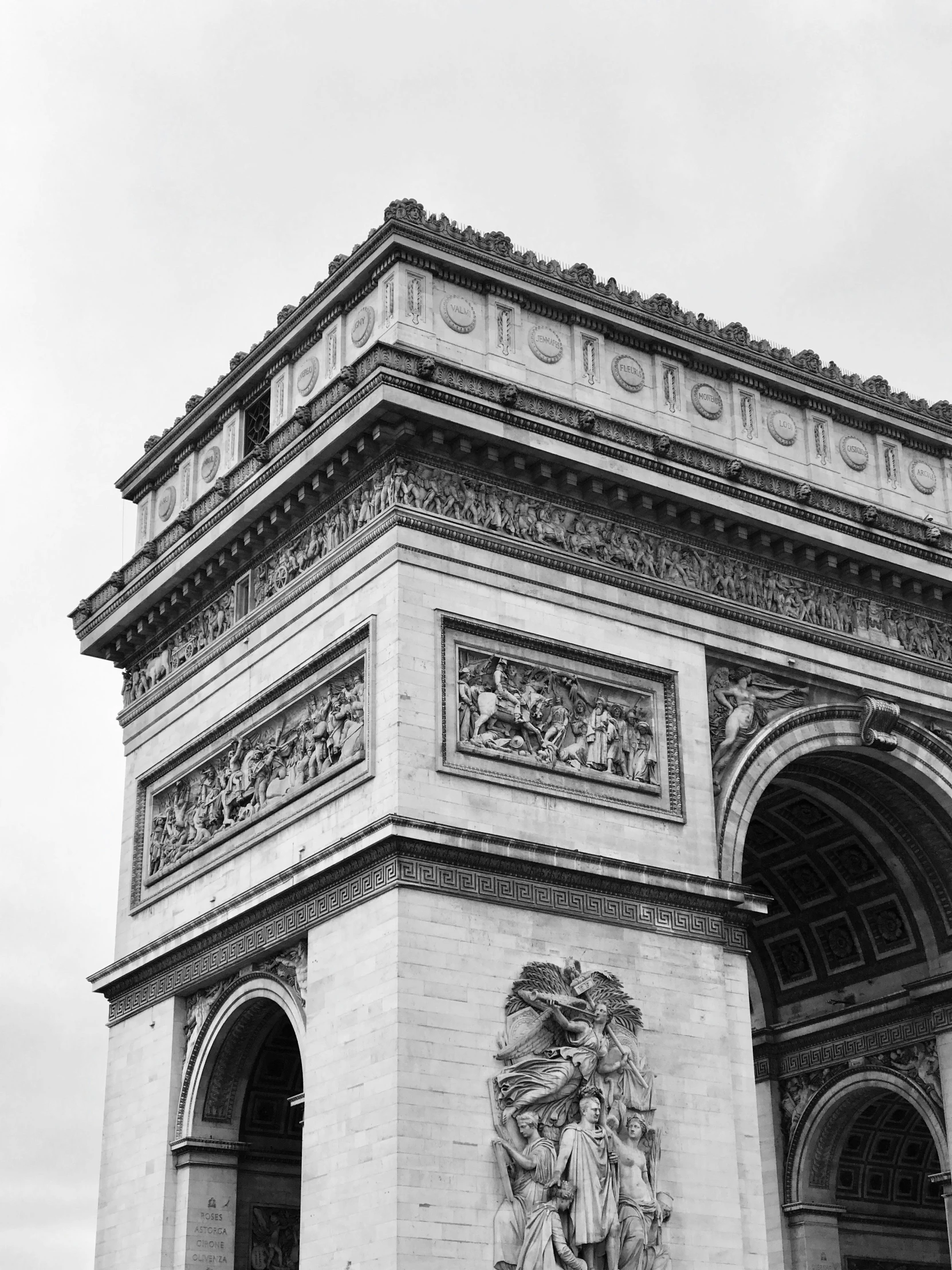 the statue of a man stands beside an arch