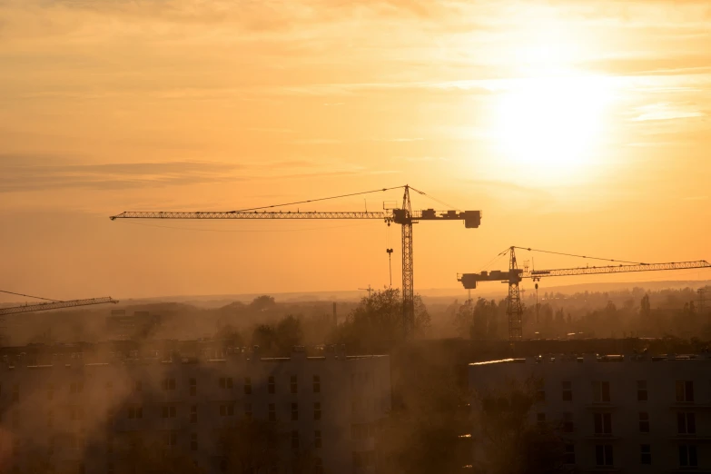 a picture of construction site with construction cranes