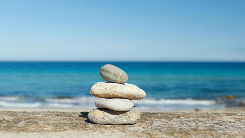 rocks stacked on top of each other near the ocean