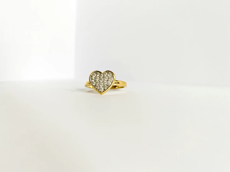 a large heart shaped diamond set in a gold ring