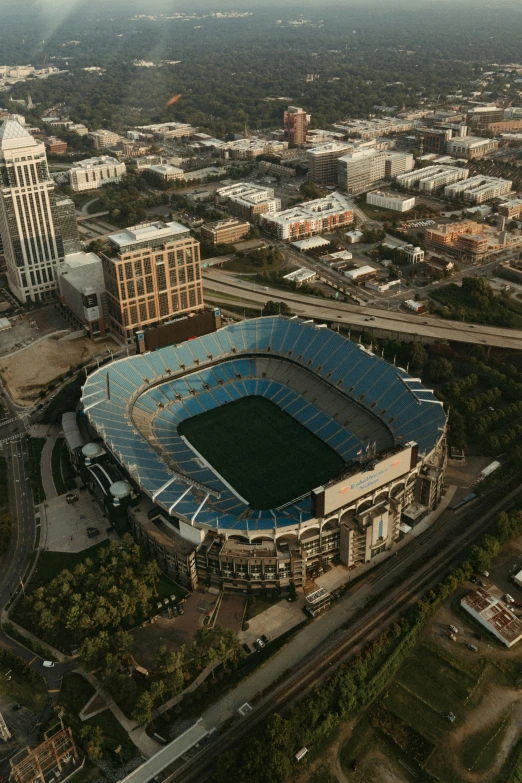 an aerial view of the atlanta skyline, with a football stadium on the right