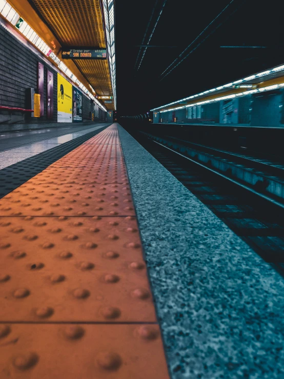 a subway train passing by a building with lights