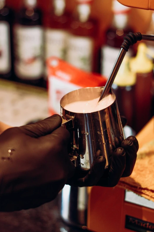 a man wearing a black glove is making soing brown