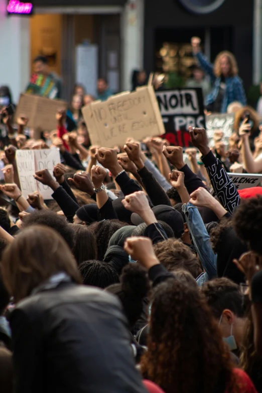 many people are protesting with their hands raised