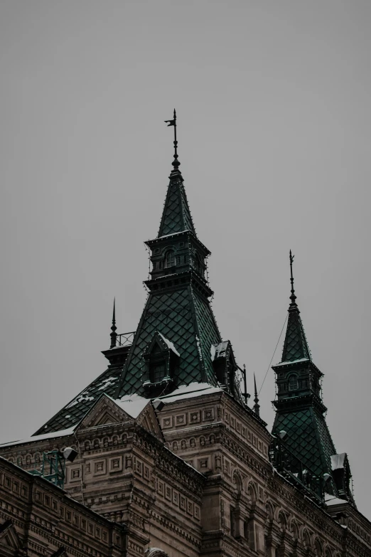 a large building has a steeple and clocks