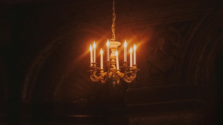 an ornate chandelier hanging in a dark room