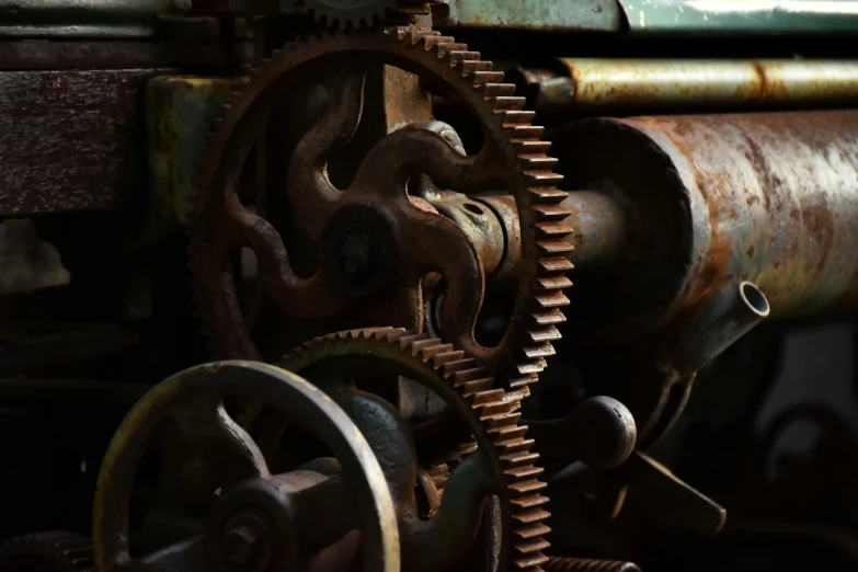 the gears and blades of an old machine are rusted