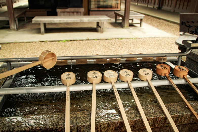 a row of wooden spoons and spoon holders