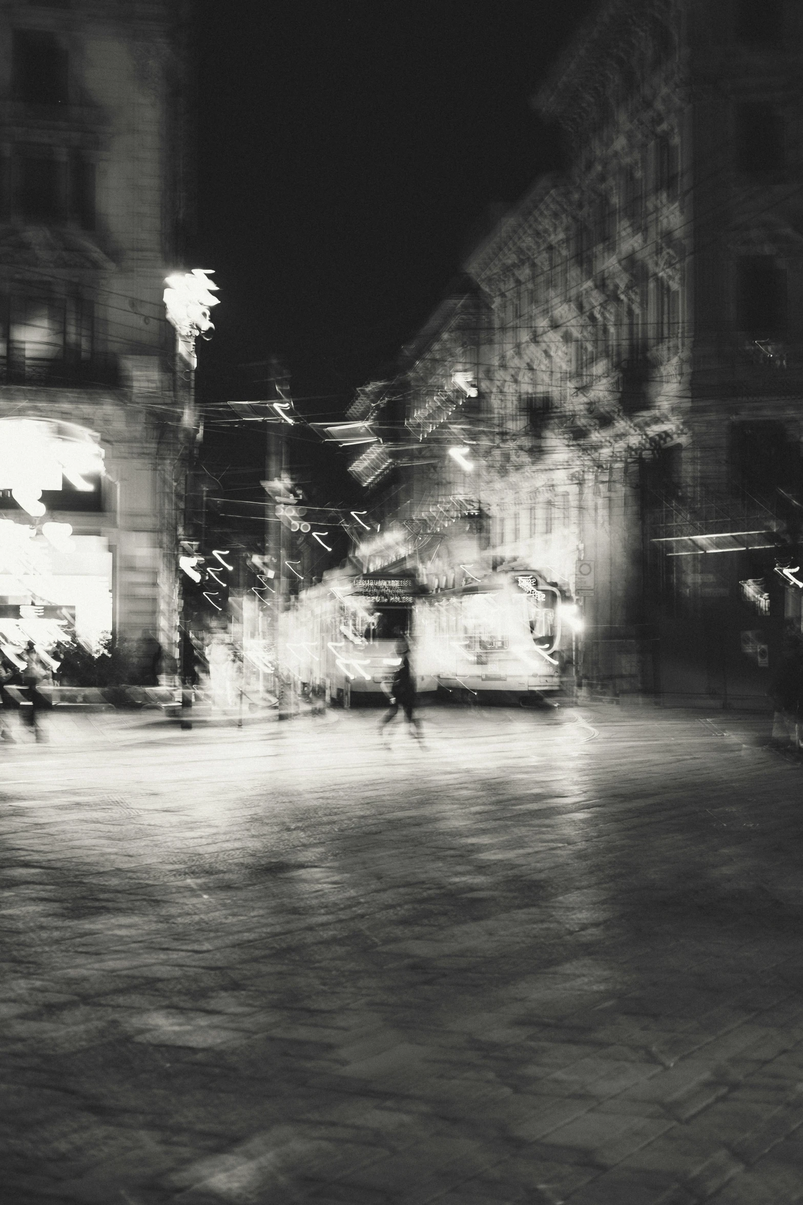 a person is walking down a cobblestone street