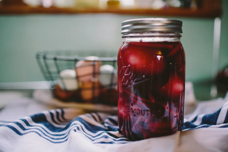 a jar full of liquid sits on the table