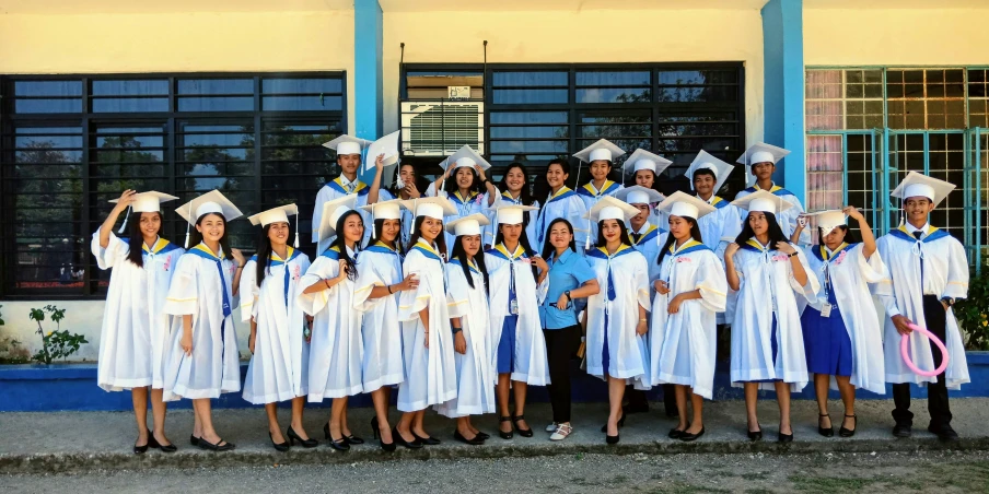 a group of graduating students in front of a building