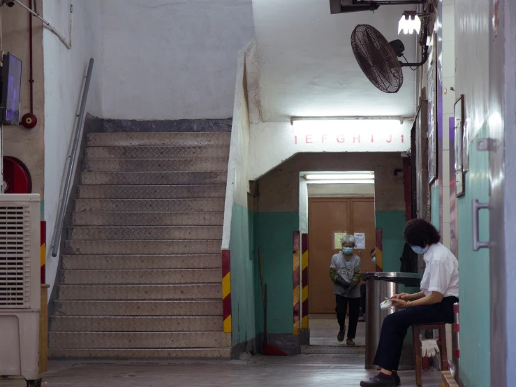 people walking in the hallways of an office building