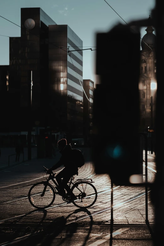 a man riding on the back of a bike across a street