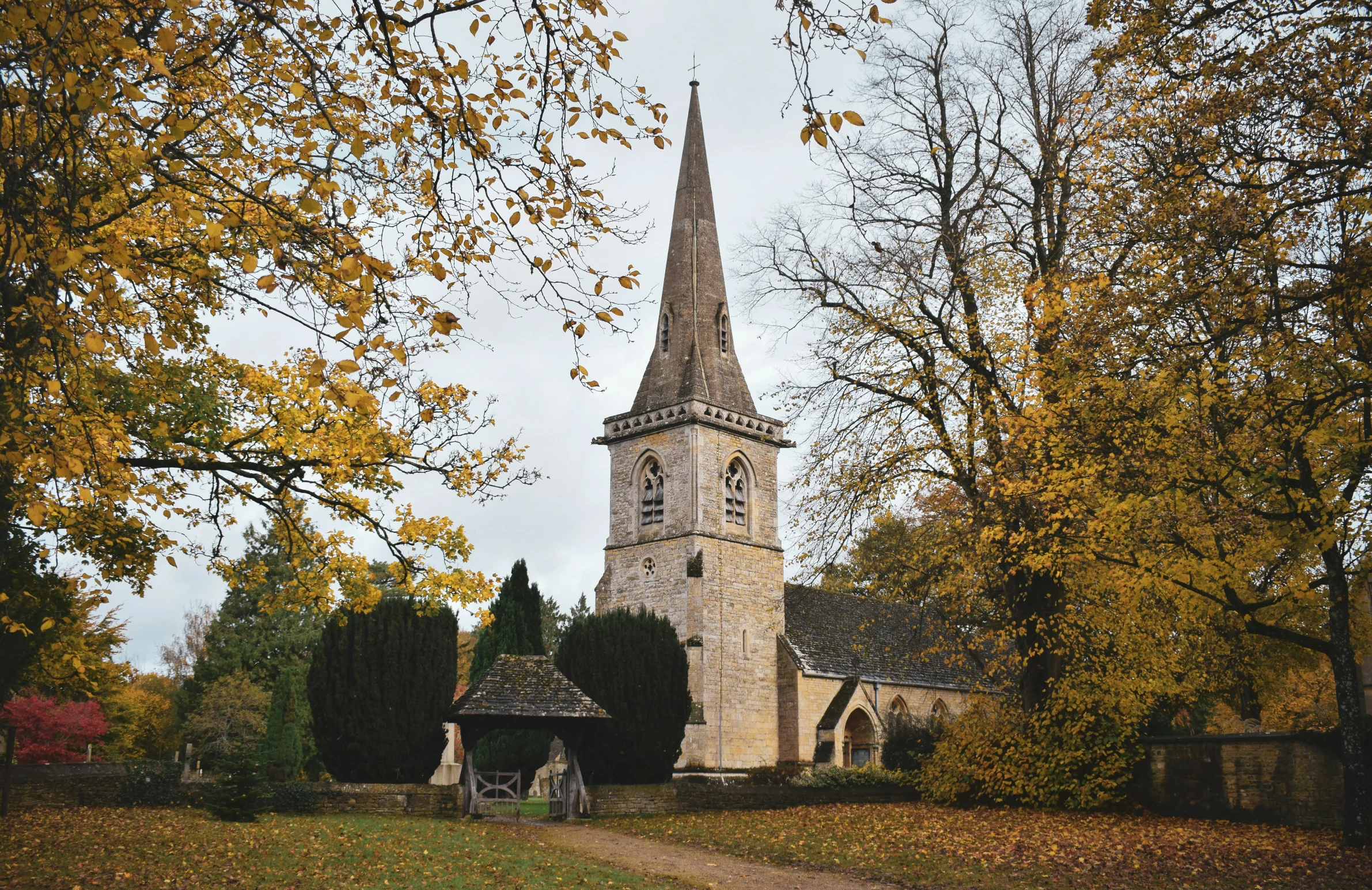 an old church sits alone surrounded by trees