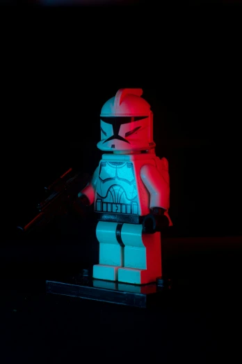 a lego star wars scene with a red light, a gun and helmet