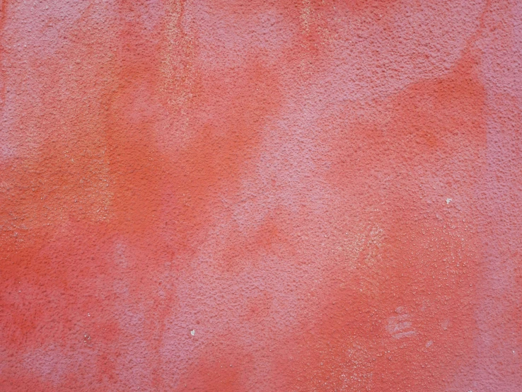 a red background from the surface of an old wall