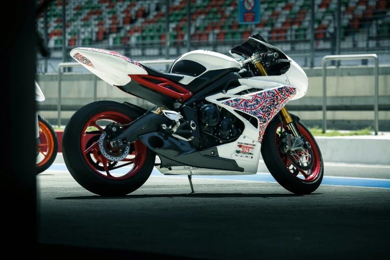 a sports bike is in front of an empty stand with seats in the background