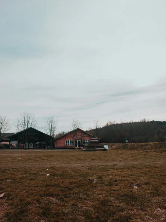 a small wooden cabin on the side of a hill